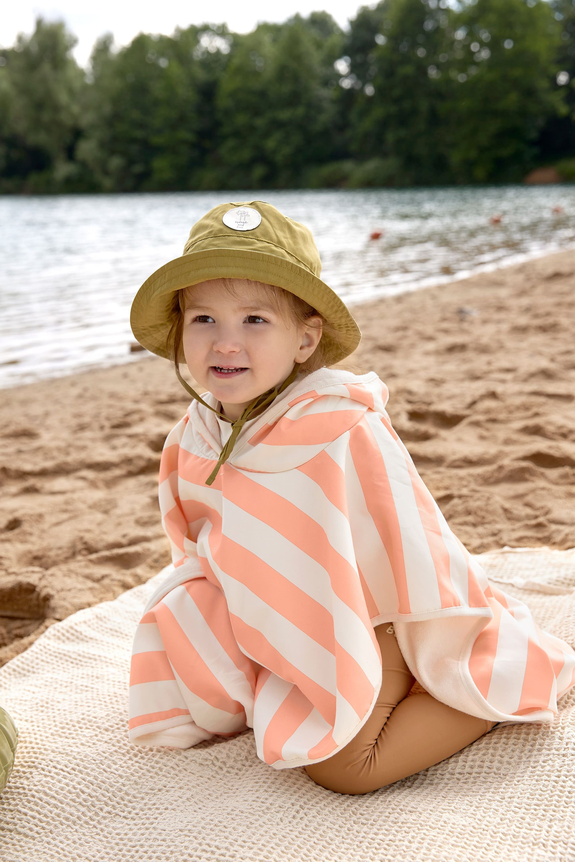 Children s anti UV beach poncho Striped off white peach Lassig